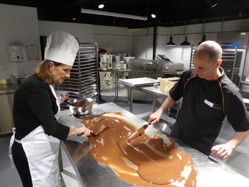 Tour de Chocolat participant works with chocolatier Blaise Poyet at Laderach studios in Vevey Switzerland (PRNewsFoto/Alpenwild)